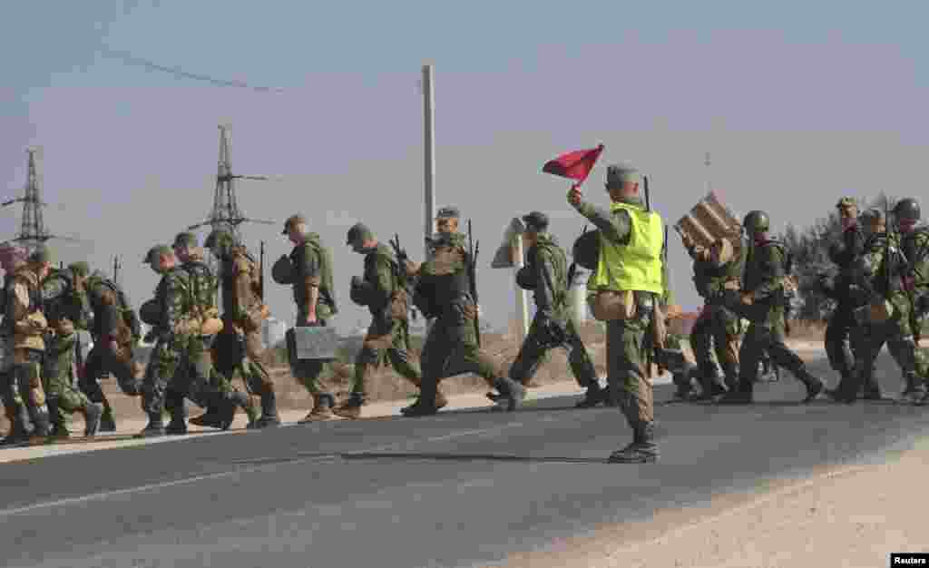 Russian marines cross a road in the Crimean port of Sevastopol, Sept. 17, 2014. 