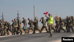 Russian marines cross a road in the Crimean port of Sevastopol, Sept. 17, 2014. 
