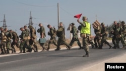 Russian marines cross a road in the Crimean port of Sevastopol, Sept. 17, 2014. 