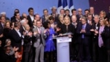 Far-right leader presidential candidate Marine Le Pen, center, stands among party officials at the end of a conference in Lyon, France, Sunday, Feb. 5, 2017.