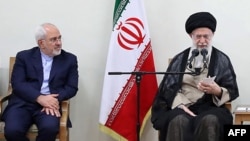 FILE - Iranian Supreme Leader Ayatollah Ali Khamenei and Foreign Minister Mohammad Javad Zarif attend a government meeting in Tehran, July 15, 2018.
