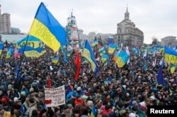 FILE - People attend a rally at Maidan Nezalezhnosti, or Independence Square, in central Kyiv, Dec. 8, 2013.
