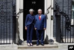 Britain's Prime Minister Theresa May greets Israeli Prime Minister Benjamin Netanyahu in Downing Street, London, June 6, 2018.