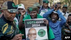 Supporters of South Africa's uMkhonto weSizwe (MK) political party protest in Johannesburg, outside the constitutional court, following the ruling that declared their leader former president Jacob Zuma ineligible as a candidate in the upcoming elections.