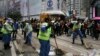 Workers sweep after police cleared barricades and tents on a main road in the occupied areas at Causeway Bay district in Hong Kong, Dec. 15, 2014.