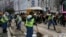 Workers sweep after police cleared barricades and tents on a main road in the occupied areas at Causeway Bay district in Hong Kong, Dec. 15, 2014.
