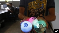Examples of a remote-controlled ball toy called Sphero is held by an employee at Sphero, a fast-growing toy robotics company in Boulder, Colorado, July 24, 2015.
