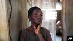 Bertha Mesilier leans against a wall, in the room she shared with her now-missing husband Edma Desravine, who was last seen seeking refuge from Hurricane Matthew, in Port-a-Piment, a district of Les Cayes, Haiti, Oct. 18, 2016.