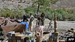 Taliban fighters stand next to ammunition along a road in Malaspa area, Bazark district, Panjshir Province on Sept. 15, 2021, days after the hardline Islamist group announced the capture of the last province resisting to their rule.