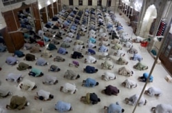 People attend evening prayers while maintaining a level of social distancing to help avoid the spread of the coronavirus, at a mosque in Karachi, Pakistan, April 19, 2020.