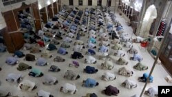 People attend evening prayers while maintaining a level of social distancing to help avoid the spread of the coronavirus, at a mosque in Karachi, Pakistan, April 19, 2020. 
