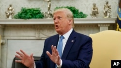 President Donald Trump speaks in the Oval Office of the White House, in Washington, July 22, 2019.