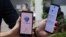 Government Technology Agency staff demonstrate Singapore's new contact-tracing smarthphone app called TraceTogether, as a preventive measure against the coronavirus in Singapore on March 20, 2020. 