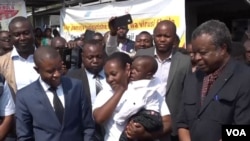 Esperance Nabintu, holding her son Ebenezer Fataki, celebrates the pair’s recovery from Ebola. Nabintu spoke at a news conference outside the treatment center in Goma, Democratic Republic of Congo, Aug. 13, 2019. (A. Malivika)