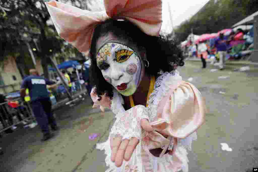 A member of the New Orleans Baby Doll Ladies walks down St. Charles Avenue ahead of the Zulu Parade during Mardi Gras in New Orleans, Louisiana.