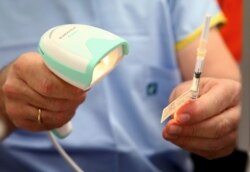 A vial of the Pfizer vaccine is scanned before administered at the Royal Prince Alfred Hospital Vaccination Hub in Sydney, Australia, Monday, Feb. 22, 2021. Australia has started its COVID-19 vaccination program days after its neighbor New Zealand…