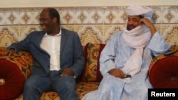 Iyad Ag Ghali, right, leader of Ansar Dine, meets with Burkina Faso foreign minister Djibril Bassole in Kidal, northern Mali, August 7, 2012.