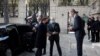 French President Emmanuel Macron, left, is welcomed by Deputy Head of Mission at the Austrian embassy Wolfgang Wagner in Paris before signing a condolence book for victims of the Vienna attack, Nov. 3 2020.