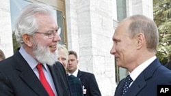 Juan Somavia, Director-General of the International Labor Organization, left, shakes hands with Russian Prime Minister Vladimir Putin at UN headquarters in Geneva, Switzerland, June 15, 2011.