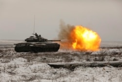 A Russian tank T-72B3 fires as troops take part in drills at the Kadamovskiy firing range in the Rostov region in southern Russia near its border with Ukraine, Jan. 12, 2022.