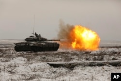 A Russian tank T-72B3 fires as troops take part in drills at the Kadamovskiy firing range in the Rostov region in southern Russia near its border with Ukraine, Jan. 12, 2022.