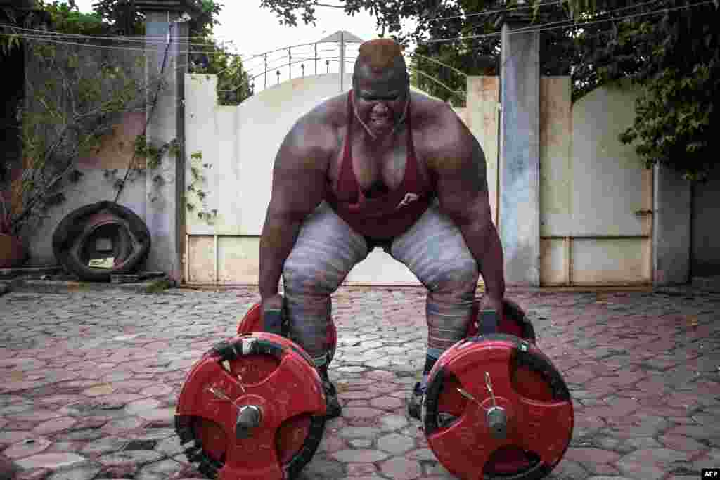 Cheick Ahmed Al-Hassan Sanou aka Iron Biby prepares to lift 300 kg as he works out at his home of Bobo-Dioulasso, second biggest city of Burkina Faso.