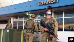 Australian soldiers stand outside the airport in Honiara, Solomon Islands, Nov. 27, 2021. 