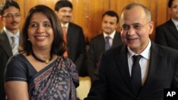 Pakistani Foreign Secretary Salman Bashir, right, shakes hands with Indian counterpart Nirupama Rao, left, prior to their talks at the Pakistan Foreign Ministry in Islamabad, Friday, June 24, 2011