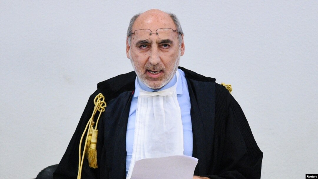 Court President Alfredo Montalto delivers the verdict in the case of an alleged people-smuggling kingpin identified as Medhanie Yehdego Mered, who said he was not the man authorities sought, in Palermo, Italy, July 12, 2019.