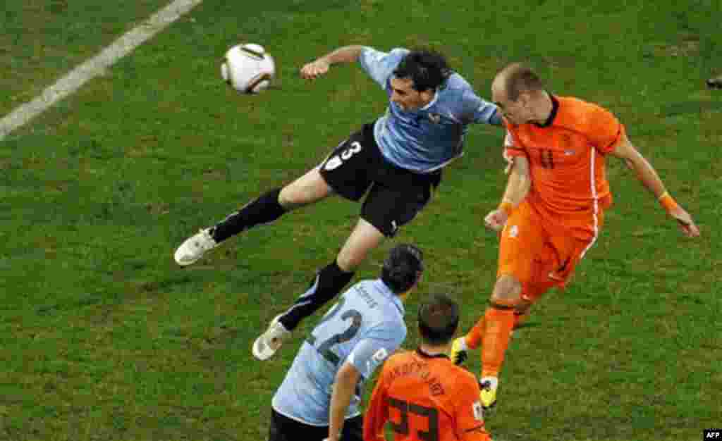 Netherlands' Arjen Robben, right, heads the ball to score his side's third goal during the World Cup semifinal soccer match between Uruguay and the Netherlands at the Green Point stadium in Cape Town, South Africa, Tuesday, July 6, 2010. The Netherlands w