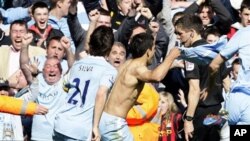 Sergio Aguero (tengah) merayakan gol penentu kemenangan Manchester City atas Queen Park Rangers hari Minggu (13/5)