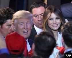 FILE - Republican President-elect Donald Trump along with his wife, Melania Trump, greet people in the crowd after delivering his acceptance speech at the New York Hilton Midtown in New York City, Nov. 9, 2016.