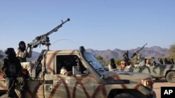 Soldiers from the rebel Niger Movement for Justice ride on armed vehicles in the desert in northern Niger in this January 14, 2008 file photo. The Niger Movement for Justice, mainly Tuareg-led, has fought the Niamey government.