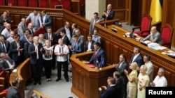 Parliament members surround Oleh Tyahnybok (C), leader of the Svoboda (Freedom) Party, as he delivers a speech at the rostrum during a session in Kyiv July 24, 2014.