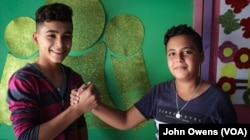 Jibril Latach, left, 16, is Lebanese and met his friend Raed, 14, a Syrian refugee, at the Beyond Association center where the choir practices.