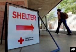 An evacuee from the Goodwin fire enters a Red Cross shelter, June 28, 2017, in Prescott Valley, Arizona.