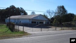 FILE - The building that once housed Superbike Motorsports sits empty in Chesnee, S.C. The building has been abandoned since four people who worked in the shop were shot to death in November 2003. Officials say the man arrested after they found a woman chained on his property killed four people and three other bodies were found on his property.