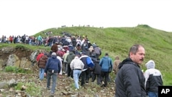 Fish processing workers and local residents head up the hill after a tsunami warning was issued in Unalaska's Dutch Harbor, in Alaska's Aleutian Islands, June 23, 2011