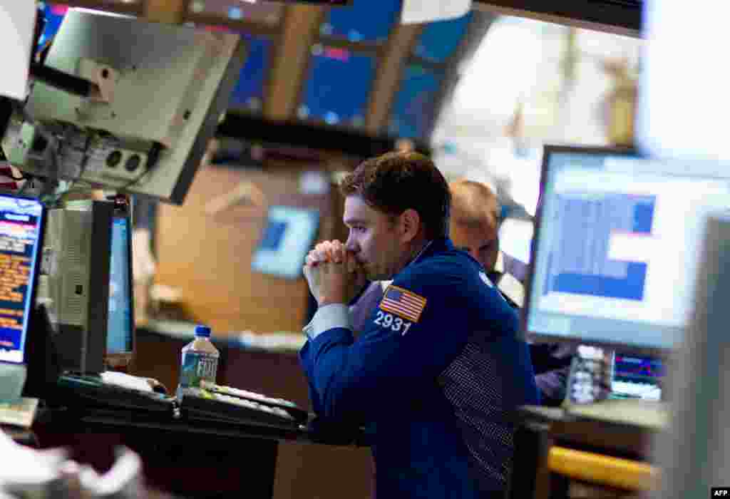 August 4: A trader works on the floor of the New York Stock Exchange in New York. The Dow plunged nearly 513 points Thursday, its biggest point decline since Oct. 22, 2008. (AP Photo/Jin Lee)