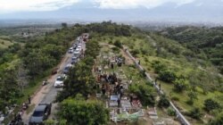 Foto Udara Lokasi Pemakaman Massal bagi korban bencana alam gempa bumi 2018 di Tempat Pemakaman Umum (TPU) Poboya Indah dengan latar Kota Palu di kejauhan. Senin (28/9/2020) Foto : Yoanes Litha