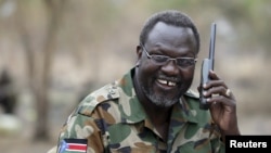 FILE - South Sudan's rebel leader Riek Machar talks on the phone in his field office in a rebel-controlled territory in Jonglei State, South Sudan, Feb. 1, 2014.