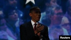 President Barack Obama waits before joining former President Bill Clinton on stage at the Democratic National Convention in Charlotte, North Carolina, September 5, 2012. 