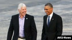 President Barack Obama walks across the tarmac with Maine Democratic gubernatorial candidate, Rep. Mike Michaud, after he arrived on Air Force One at the Portland International Jetport, Oct. 30, 2014.