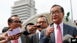 FILE - Cambodia's exiled opposition leader Sam Rainsy talks to the media outside Parliament House in Kuala Lumpur, Malaysia, Tuesday, Nov. 12, 2019. (AP Photo/Vincent Thian)