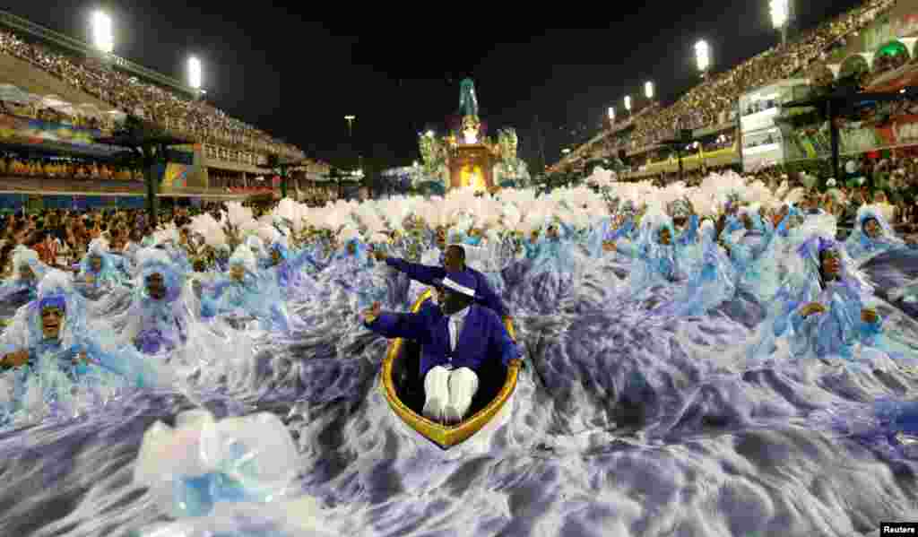 Revellers from Portela samba school perform during the second night of the carnival parade at the Sambadrome in Rio de Janeiro, Brazil.