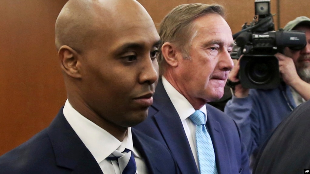 FILE -- Mohamed Noor, left, former Minneapolis police officer, leaves the Hennepin County Government Center in Minneapolis with attorney Peter Wold after a hearing to address several pretrial motions, March 1, 2019. 