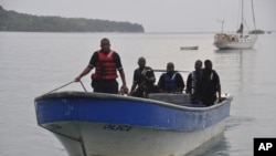 Jamaican Marine Police return to the Port Antonio Marina after a fruitless search for a plane that crashed into the ocean near Port Antonio, Jamaica, Sept. 5, 2014. 