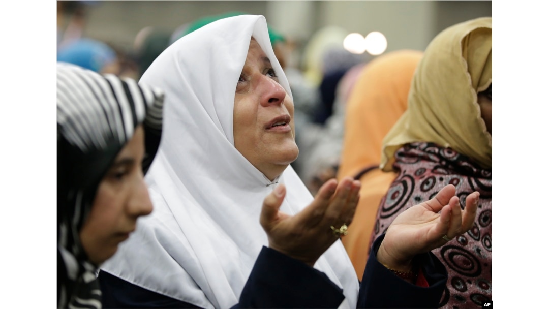 A Muslim woman prays before Muhammad Ali's Jenazah, a traditional Islamic service, at Freedom Hall in Louisville, Ky., June 9, 2016.