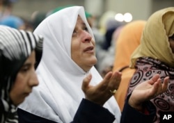 A Muslim woman prays before Muhammad Ali's Jenazah, a traditional Islamic service, at Freedom Hall in Louisville, Ky., June 9, 2016.