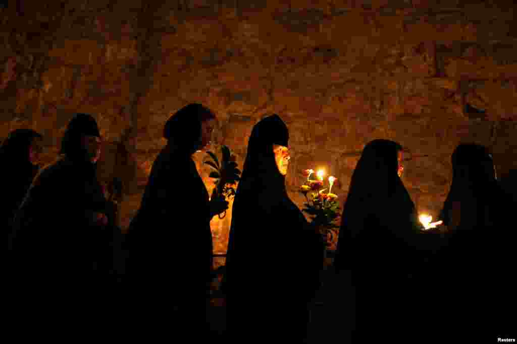 Orthodox Christian nuns take part in an annual procession along the Via Dolorosa in Jerusalem&#39;s Old City. An icon of the Virgin Mary is carried from the Church of the Holy Sepulchre to a church at the foot of the Mount of Olives, the location believed by Christians to be that of the tomb of the Virgin Mary.